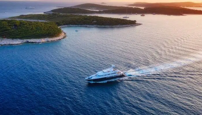 Aerial view on the luxury yacht during sunset