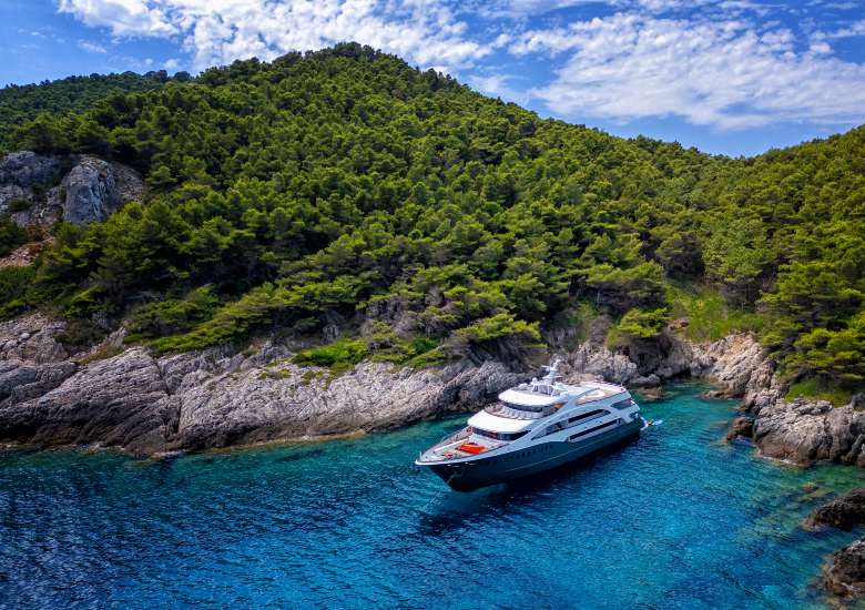A view of the ship Aretis in a secluded turquoise bay in Croatia